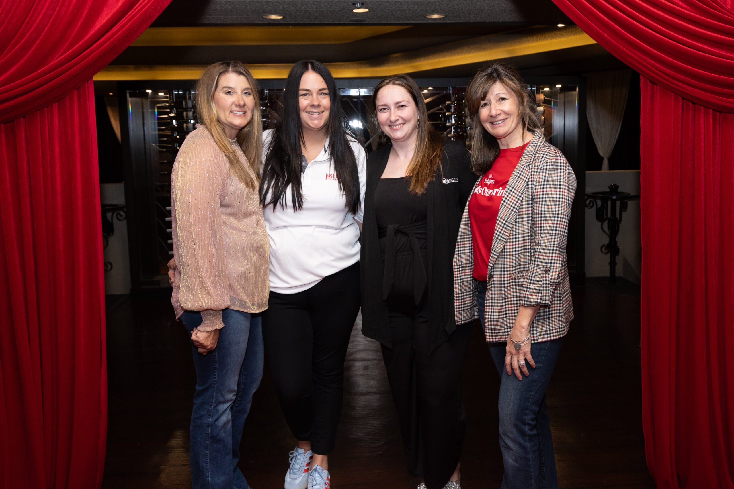 group of four women pose for a photo