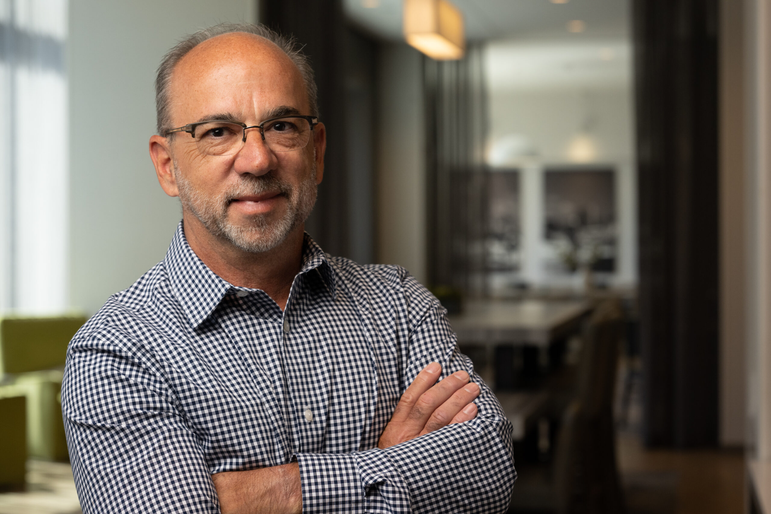 headshot of Jim Carbone, VP of coffee experience at WithMe, Inc. looking at the camera with his arms crossed.