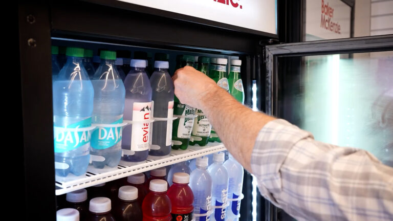 Man reaching in micro market cooler for water