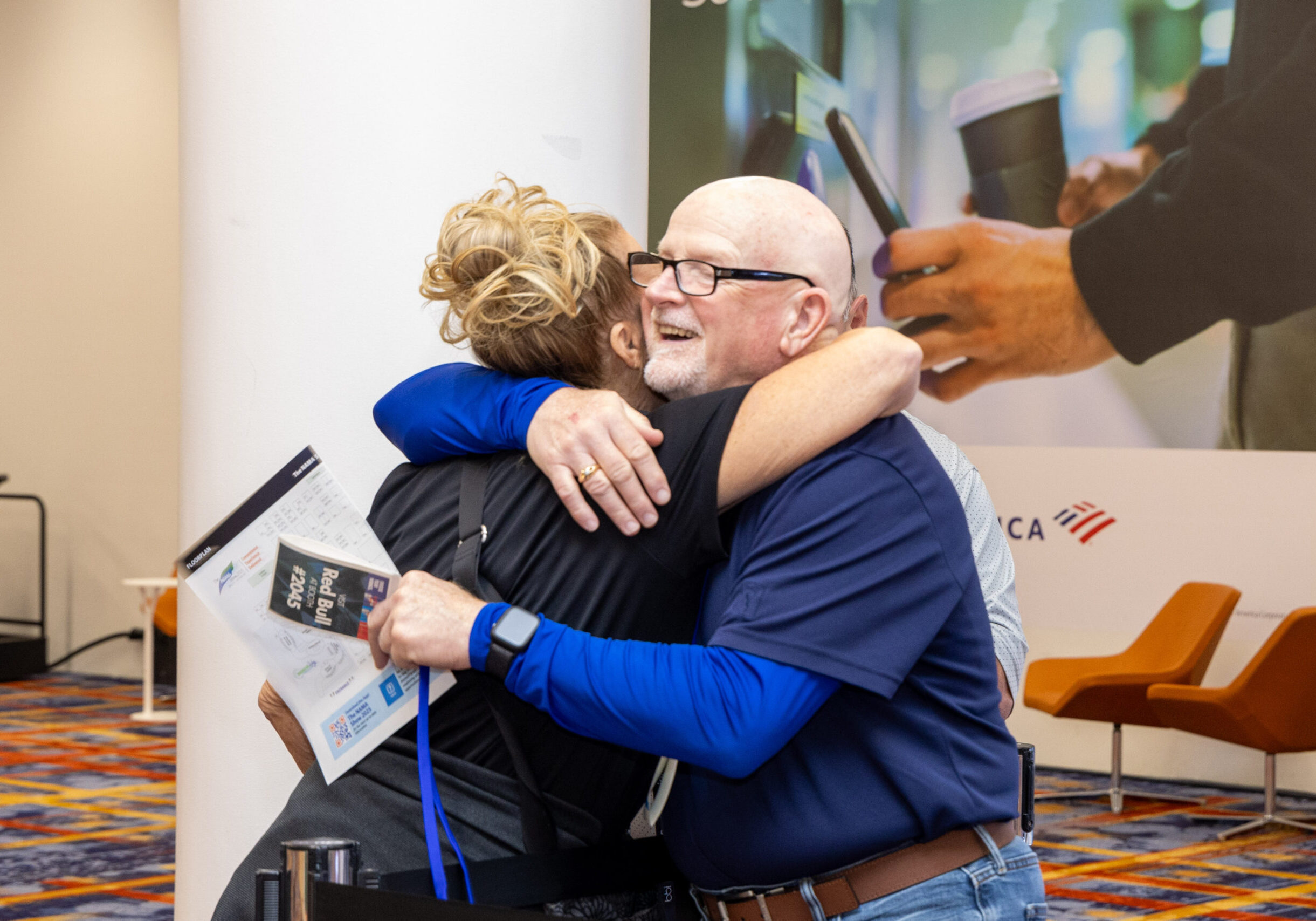 Two NAMA members hugging