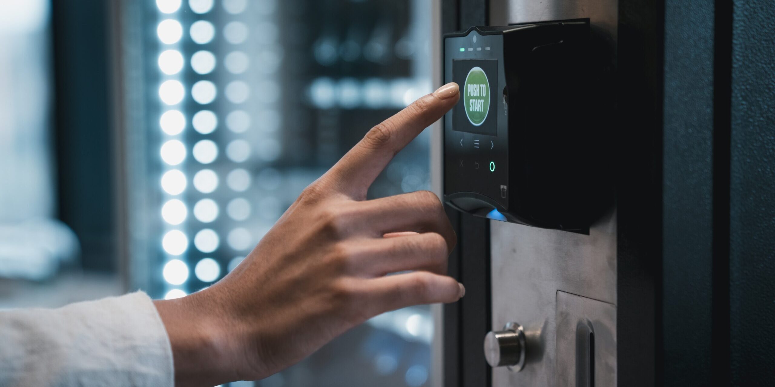 a hand is shown pressing the cashless payment option on a smart cooler
