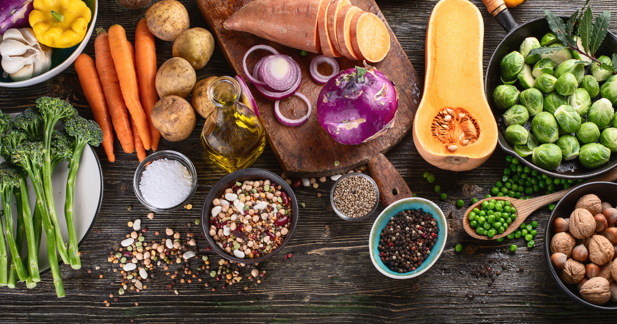 a variety of fresh ingredients scattered around a dark brown table.