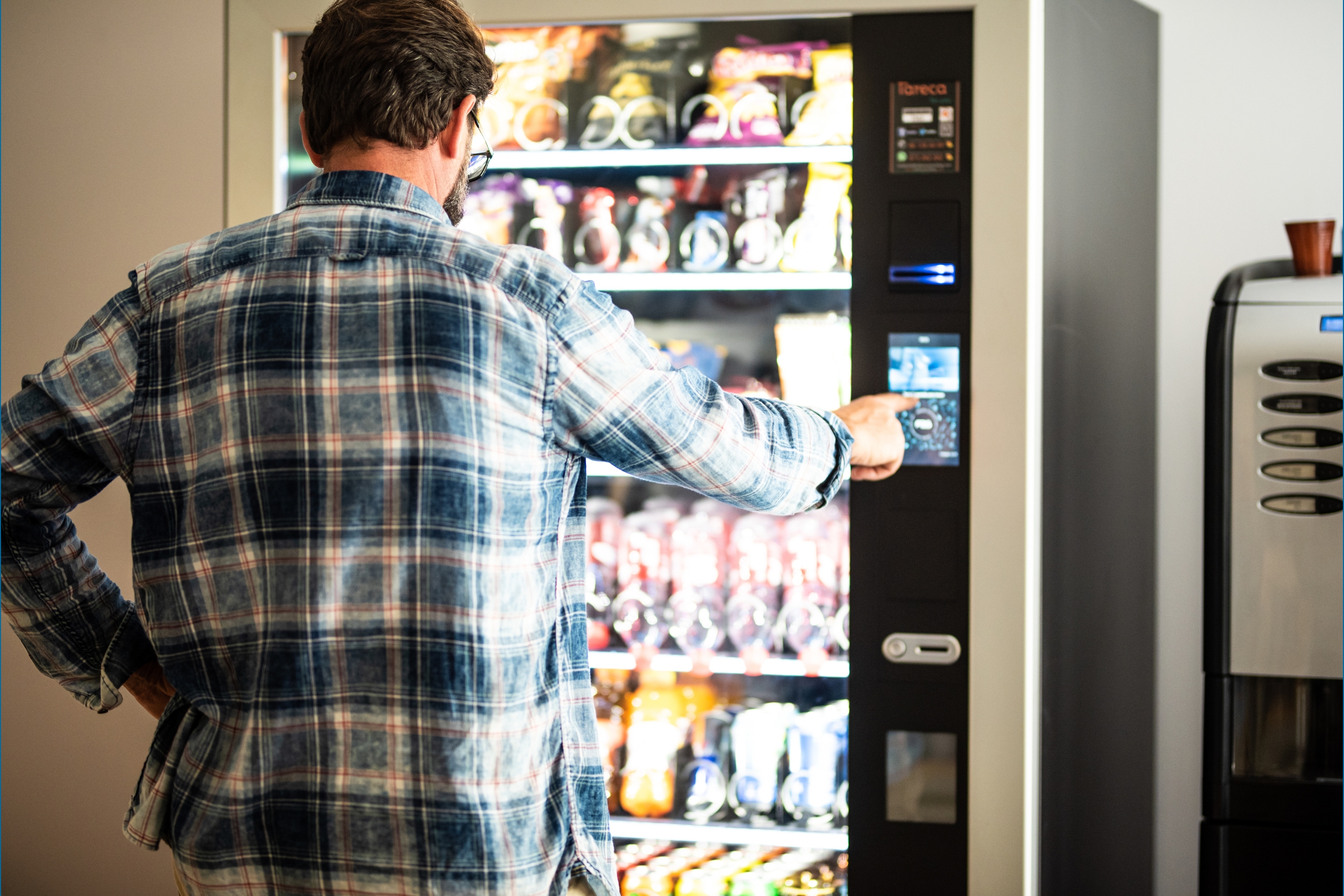 Man purchasing vending machine product