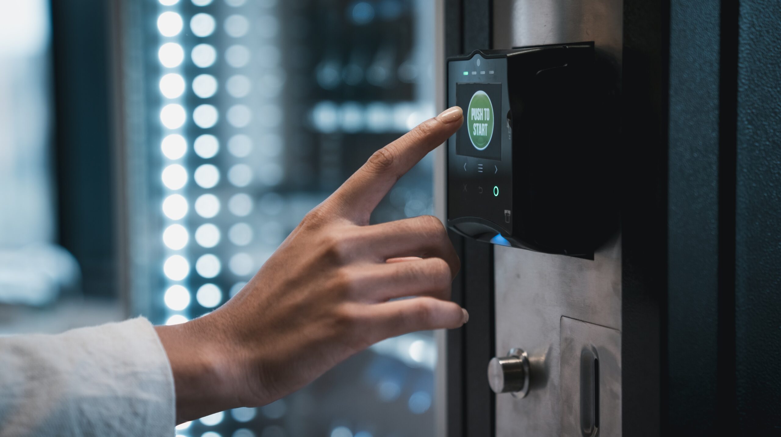 a hand is shown pressing the cashless payment option on a smart cooler