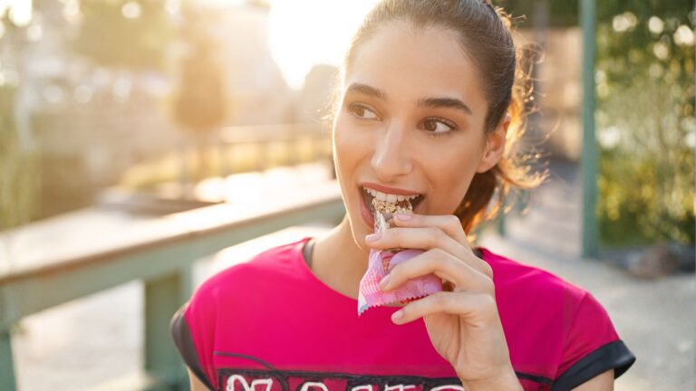 woman eating protein bar | Trends in convenience services food choice